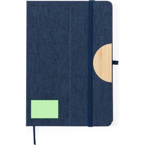 A navy blue notepad with a wooden accent and a green sticky note section, featuring an elastic band closure.
