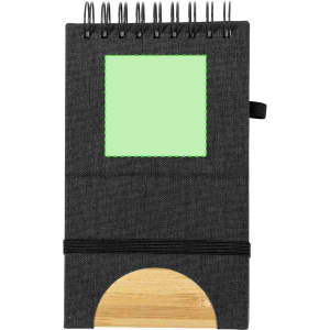 A black notebook with a spiral binding, featuring a green square and a wooden base for holding items.