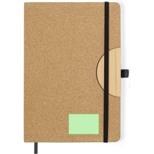 A cork-covered notepad with a wooden accent, featuring a black elastic band and a green sticky note area.