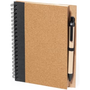 A brown cork notebook with a black spine and a pen attached. It features spiral binding and a simple design.