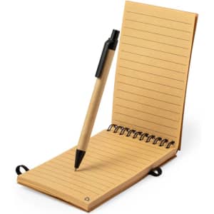 A tan notebook with lined pages rests open, accompanied by a black pen, featuring a spiral binding.