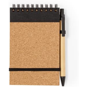 A cork notebook with a spiral binding, featuring a black top section and accompanied by a black pen.