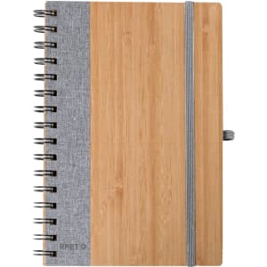 A notebook with a bamboo cover and grey fabric spine, featuring a spiral binding and an elastic band closure.