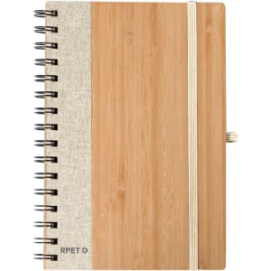 A notebook with a bamboo cover and a fabric side, featuring a spiral binding and an elastic strap.