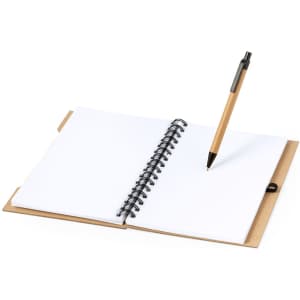 A spiral-bound notebook with a brown cover and white pages, accompanied by a black pen.