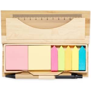 An office set in a bamboo holder featuring pink, yellow, and green sticky notes, flags, and a pen with a ruler.