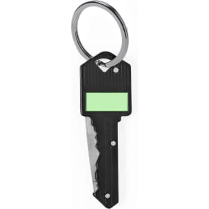 A black pocket knife shaped like a key, attached to a metal keyring, featuring a green label area.