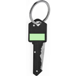A black key with a green label and a keyring attached. It features a textured surface and a serrated edge.