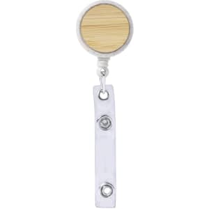 A badge reel with a circular bamboo top and a clear plastic retractable strap.