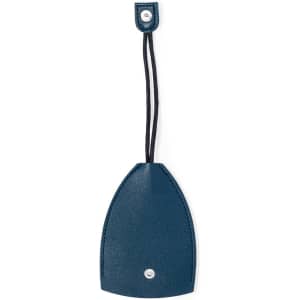 A navy blue keyring with a smooth surface and a black cord for attachment, featuring a snap button.