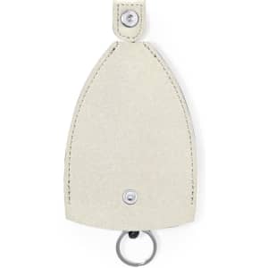 A keyring with a textured cream pouch design, featuring a silver keyring attachment and a stud button.