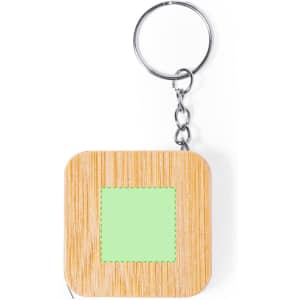A square tape measure in wood with a green section, attached to a metal keyring.