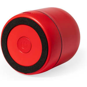 A round red speaker with a black base and power button, featuring a smooth, glossy finish and a sleek design.