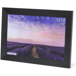 A digital photo frame with a black border, displaying a vibrant landscape of lavender fields and a time and weather indicator.