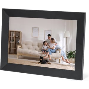 A digital photo frame in black showcasing a family on a sofa with a small dog on a carpeted floor.