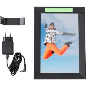 A black digital photo frame featuring a vibrant image of a person jumping, accompanied by a stand and power accessories.