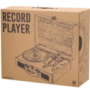 A brown cardboard box for a Vinilux record player, featuring an illustration of the player and its components.