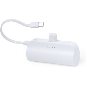 A white power bank with a USB-C cable attached, featuring LED indicator lights and a compact design.