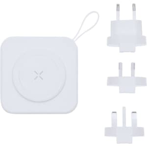 A white multifunction travel adapter with interchangeable plug heads. The adapter features a circular charging area.