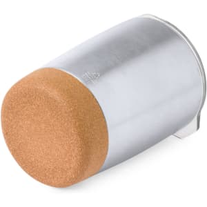 An insulated travel mug with a silver stainless steel body and a tan cork base. It features a logo.