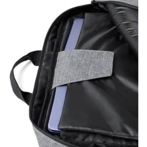 A grey laptop bag backpack interior featuring a purple laptop secured with a strap against a black lining.