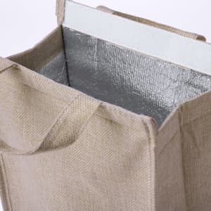 A cooler bag made of natural fibre with a silver insulated interior. It has sturdy handles for easy carrying.