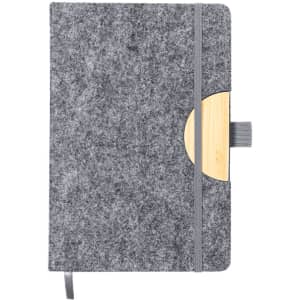 A grey notepad with a wooden circular accent and an elastic closure, featuring a logo on the cover.