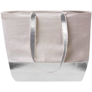 A tote bag in a cream colour with a shiny silver accent at the bottom and silver handles. Features a logo.