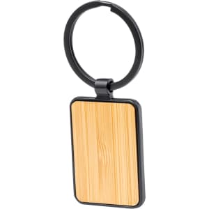 A rectangular keyring featuring a bamboo panel and a black metal ring. The keyring has a sleek, modern design.