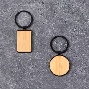 A bamboo keyring set featuring one rectangular and one circular design, both with black metal accents.