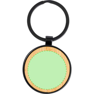 A round keyring featuring a black metal outer rim and a light green insert with a bamboo texture.