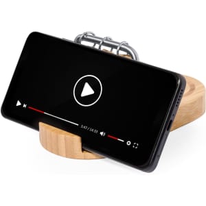 A wooden phone stand displaying a smartphone with a video playback interface. The design is minimalistic and functional.