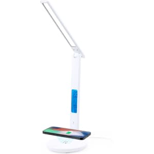 A multifunction lamp in white featuring a wireless charging pad and a digital display.