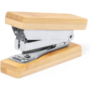 A stapler made of silver metal with wooden bamboo handles, featuring a sleek, minimalist design.