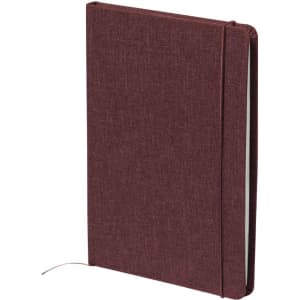 A maroon notepad with a textured cover, featuring a ribbon bookmark and a logo on the front.