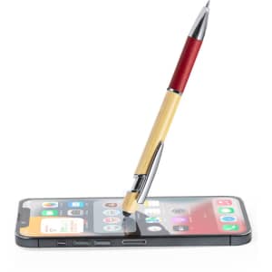 A stylus touch ball pen with a red and bamboo design rests on a smartphone, showcasing its dual functionality.