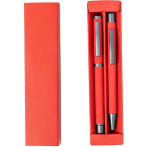 A red gift box containing two metal pens, featuring a sleek design and a black accent. The box has a logo on it.