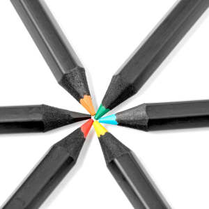 A set of coloured pencils with black bodies and vibrant tips in green, yellow, red, and blue, arranged in a circular pattern.