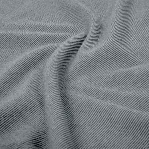 A close-up of a soft, grey polar fleece fabric showing its textured surface and gentle drape.