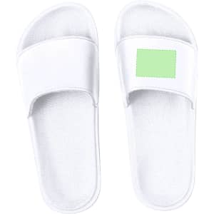 White flip flops with a smooth design and a green patch on the side, featuring a logo.