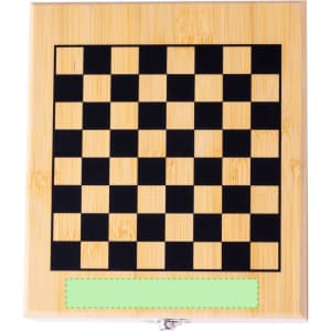 A wooden chessboard featuring a black and natural bamboo pattern with a blank green label at the bottom.