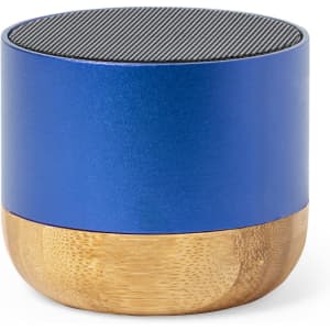 A compact speaker featuring a blue metallic upper section and a bamboo base. It has a textured top grille.