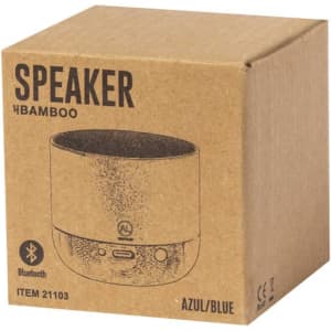 A bamboo Bluetooth speaker in a blue and brown cardboard box with a logo.