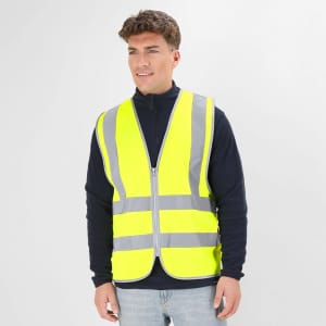 A reflective vest in bright yellow with grey stripes, featuring a zip front and worn by a model.
