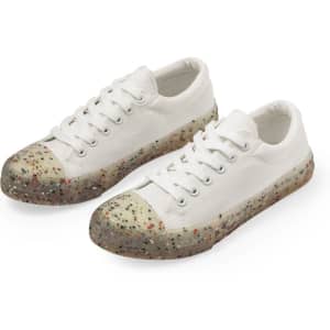 A pair of white trainers featuring a multi-coloured speckled sole and laces. The shoes have a casual design.