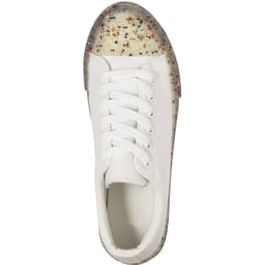 A white sneaker with a speckled translucent sole and laces, featuring a simple design and branding.