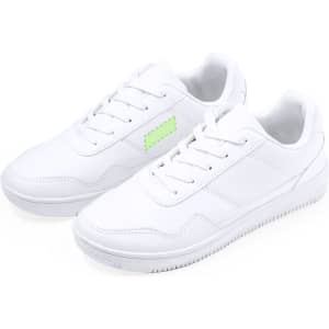 A pair of white trainers with a simple design and a small green branding detail on the side.