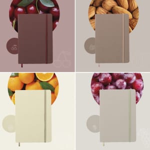 A set of four notepads in red, beige, white, and green, each surrounded by fruit and nut imagery and featuring logos.