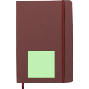 A brown notepad with a green placeholder and a red elastic band. It features a logo on the cover.