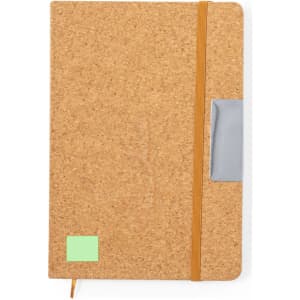 A cork notebook with an orange elastic band and a grey pocket, featuring a green sticky note on the front.